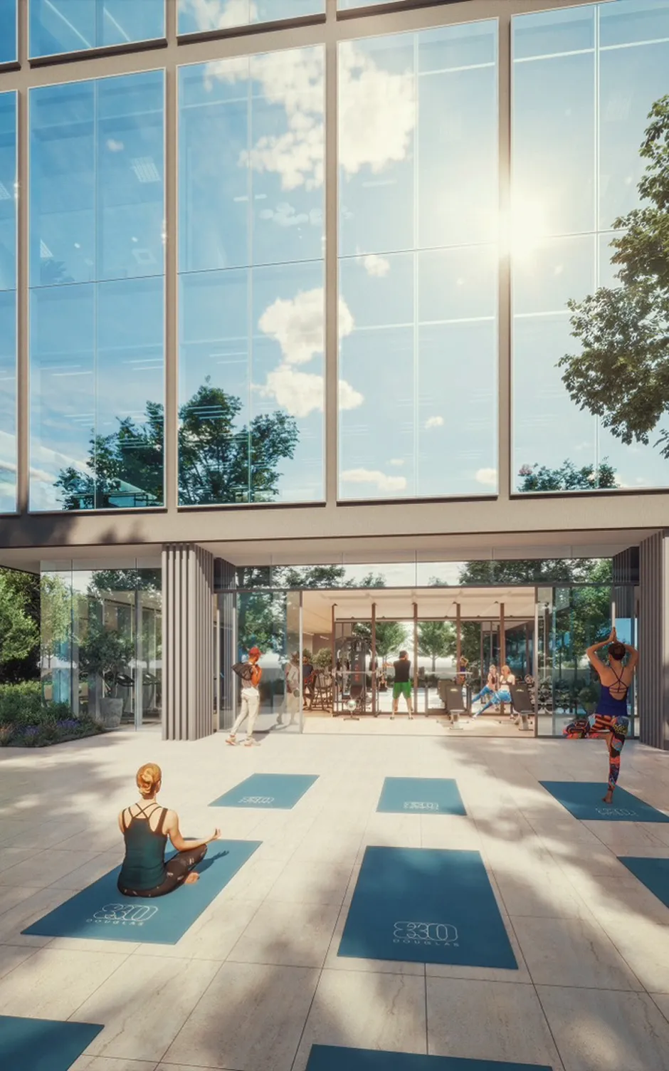 Wellness area with outdoor mats, gym interior, and sunlight streaming through large glass facade